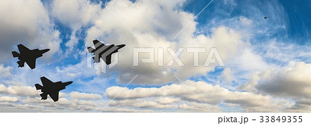 Silhouettes of three F-35 aircraft in the sky  33849355