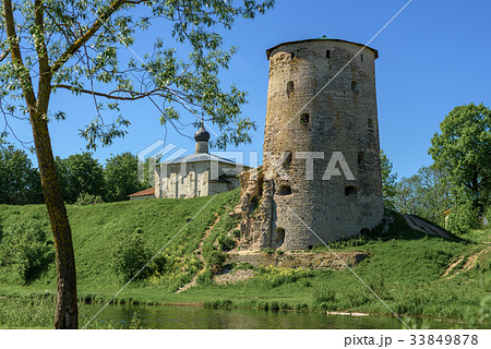 An old tower made of limestone and a small Church An old tower made of limestone and a small Church 33849878