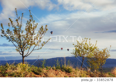 Hot air balloon flying over spectacular Cappadocia Hot air balloon flying over spectacular Cappadocia 33852878