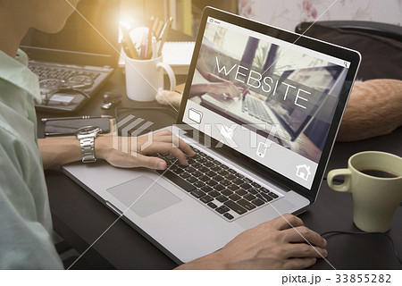 typing on a laptop keyboard with Website homepage typing on a laptop keyboard with Website homepage 33855282