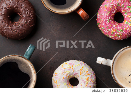 Coffee cups and colorful donuts Coffee cups and colorful donuts 33855636