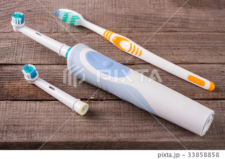 electric and manual toothbrushes on the wooden 33858858