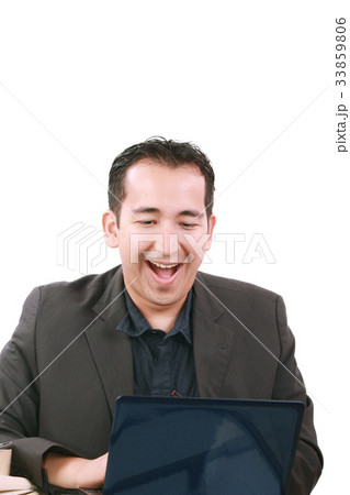 Happy young man working on laptop computer 33859806