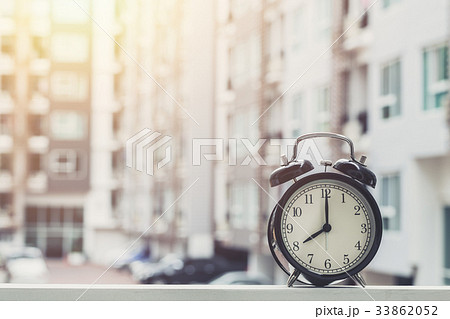 8 o'clock retro clock with condominium background. 33862052