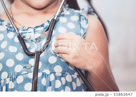 asian child girl with stethoscope playing doctor asian child girl with stethoscope playing doctor 33863647