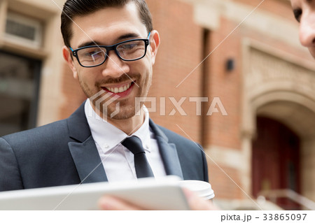 Two businessmen talking outdoors 33865097