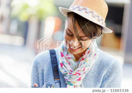 Outdoor summer smiling lifestyle portrait of pretty young woman with camera Outdoor summer smiling lifestyle portrait of pretty young woman with camera 33865336