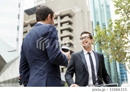 Two businessmen talking outdoors Two businessmen talking outdoors 33866153