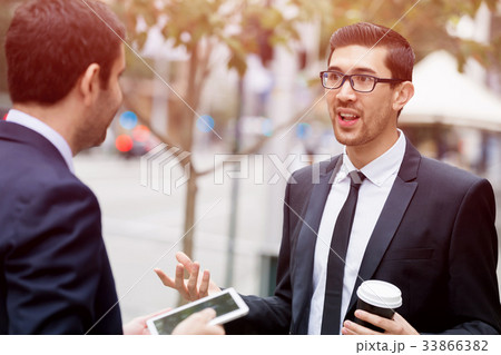 Two businessmen talking outdoors Two businessmen talking outdoors 33866382
