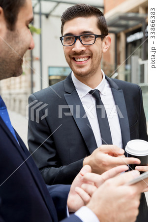 Two businessmen talking outdoors 33866383
