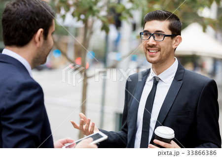 Two businessmen talking outdoors 33866386