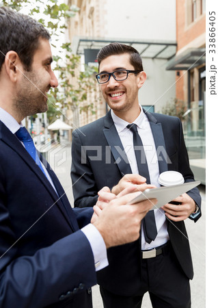 Two businessmen talking outdoors Two businessmen talking outdoors 33866405