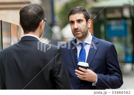 Two businessmen talking outdoors Two businessmen talking outdoors 33866562