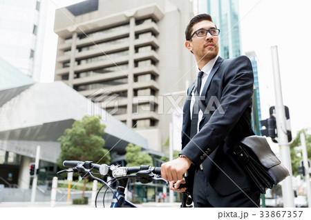 Young businessmen with a bike Young businessmen with a bike 33867357