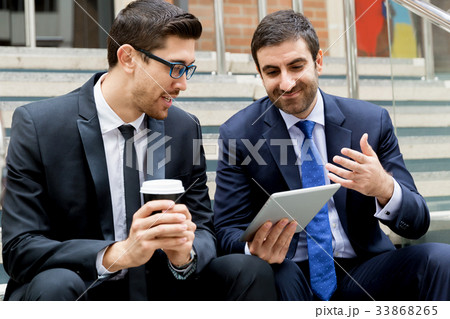 Two businessmen talking outdoors Two businessmen talking outdoors 33868265