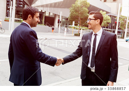 Two businessmen shaking their hands Two businessmen shaking their hands 33868857