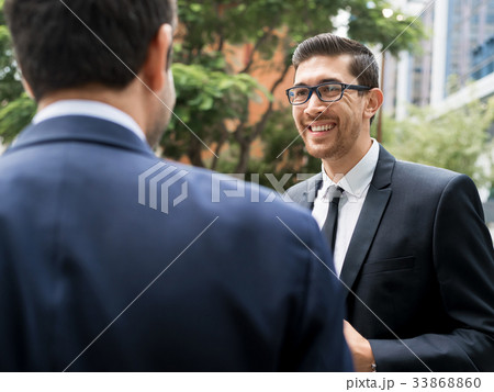 Two businessmen talking outdoors Two businessmen talking outdoors 33868860