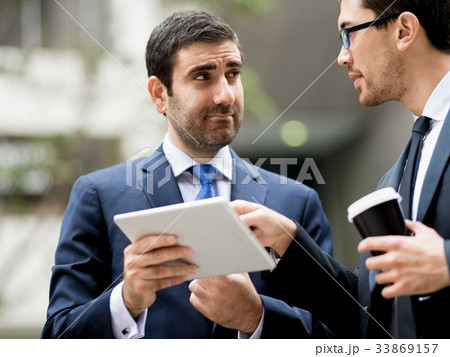 Two businessmen talking outdoors Two businessmen talking outdoors 33869157