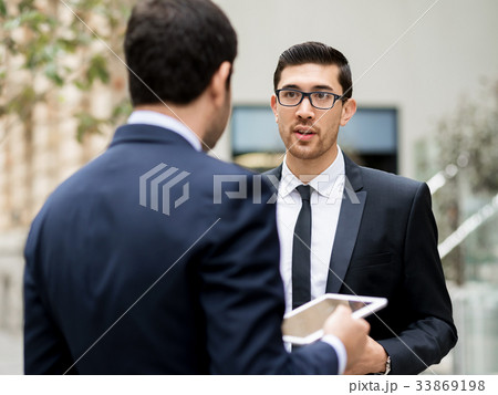 Two businessmen talking outdoors 33869198