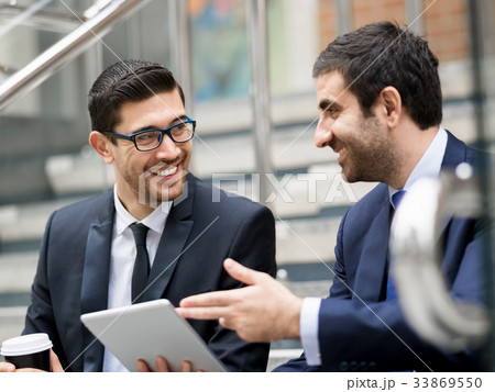 Two businessmen talking outdoors 33869550