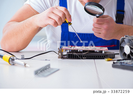 Computer repairman repairing desktop computer Computer repairman repairing desktop computer 33872259