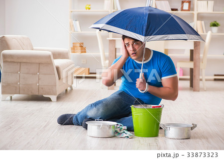 Man at home dealing with neighbor flood leak Man at home dealing with neighbor flood leak 33873323