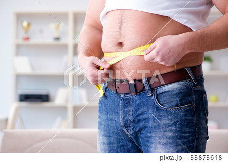 Man suffering from extra weight in diet concept Man suffering from extra weight in diet concept 33873648