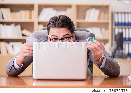 Businessman gambling playing cards at work Businessman gambling playing cards at work 33875533