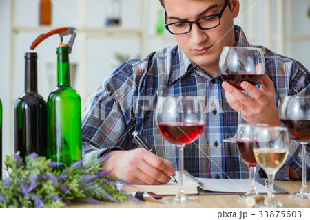 Professional sommelier tasting red wine Professional sommelier tasting red wine 33875603