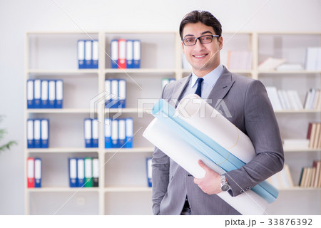 Businessman engineer draftsman with blueprints 33876392