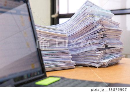 computer notebook and documents on desk  33876997