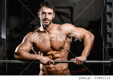 Caucasian sexy fitness male model execute exercise with barbell Caucasian sexy fitness male model execute exercise with barbell 33881113