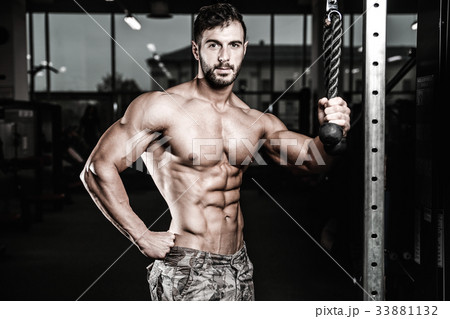 Caucasian sexy fitness model in gym close up abs. Caucasian sexy fitness model in gym close up abs. 33881132