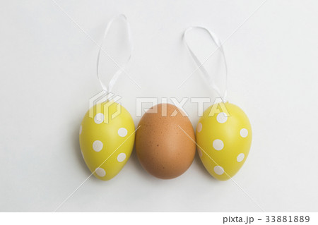 Natural egg and two Easter plastic artificial eggs Natural egg and two Easter plastic artificial eggs 33881889