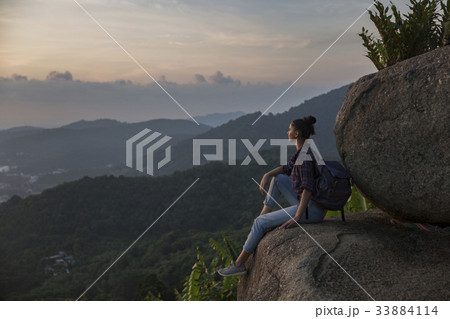 Hipster young girl with backpack enjoying sunset Hipster young girl with backpack enjoying sunset 33884114