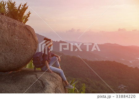 Hipster young girl with backpack enjoying sunset 33884220
