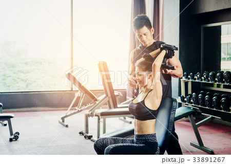 Sport girl doing weight exercises working 33891267