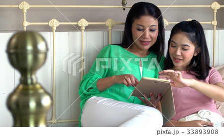 Beautiful mother and pretty daughter sharing happy 33893908