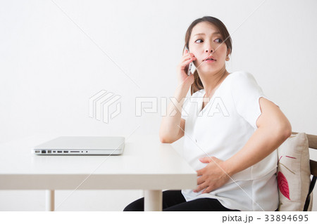 スマートフォンで話す妊婦さん 33894695