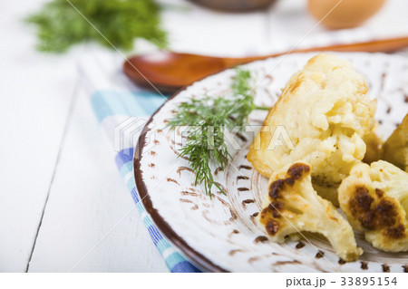 Fried cauliflower on a wooden table. 33895154