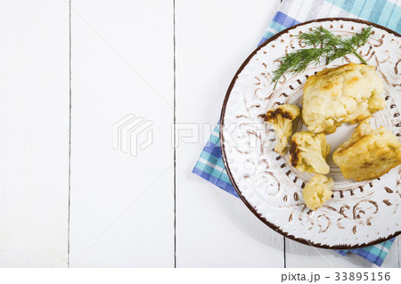 Fried cauliflower on a wooden table. Fried cauliflower on a wooden table. 33895156