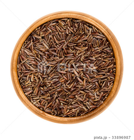 Camargue red rice grains in wooden bowl 33896987