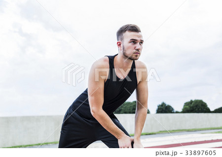 Athlete preparing for training on running track Athlete preparing for training on running track 33897605