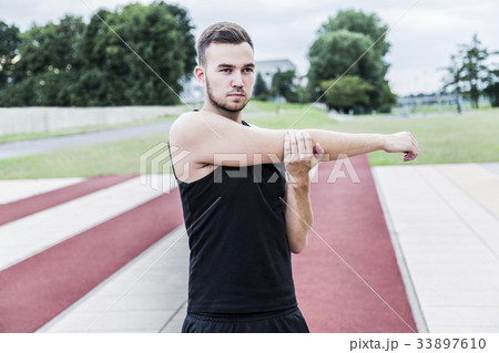 Athlete preparing for training on running track Athlete preparing for training on running track 33897610
