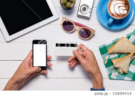 Hipster man hands holding a credit card Hipster man hands holding a credit card 33899414