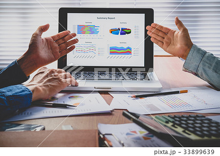 Business partners discussing financial data Business partners discussing financial data 33899639
