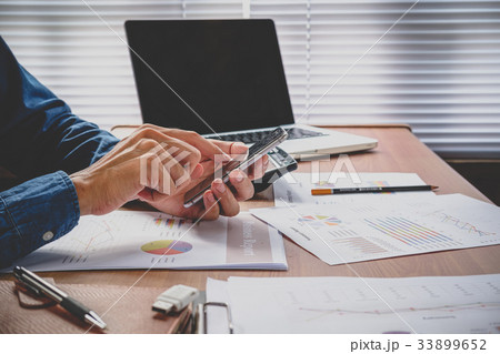 Businessman working and using smart phone Businessman working and using smart phone 33899652