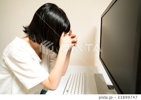 パソコンの前で落ち込む女性 33899747