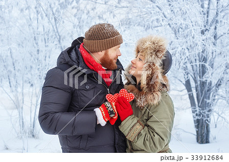 young couple in winter forest young couple in winter forest 33912684