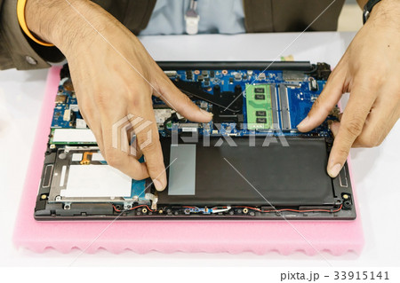 Laptop disassembling with screwdriver. 33915141